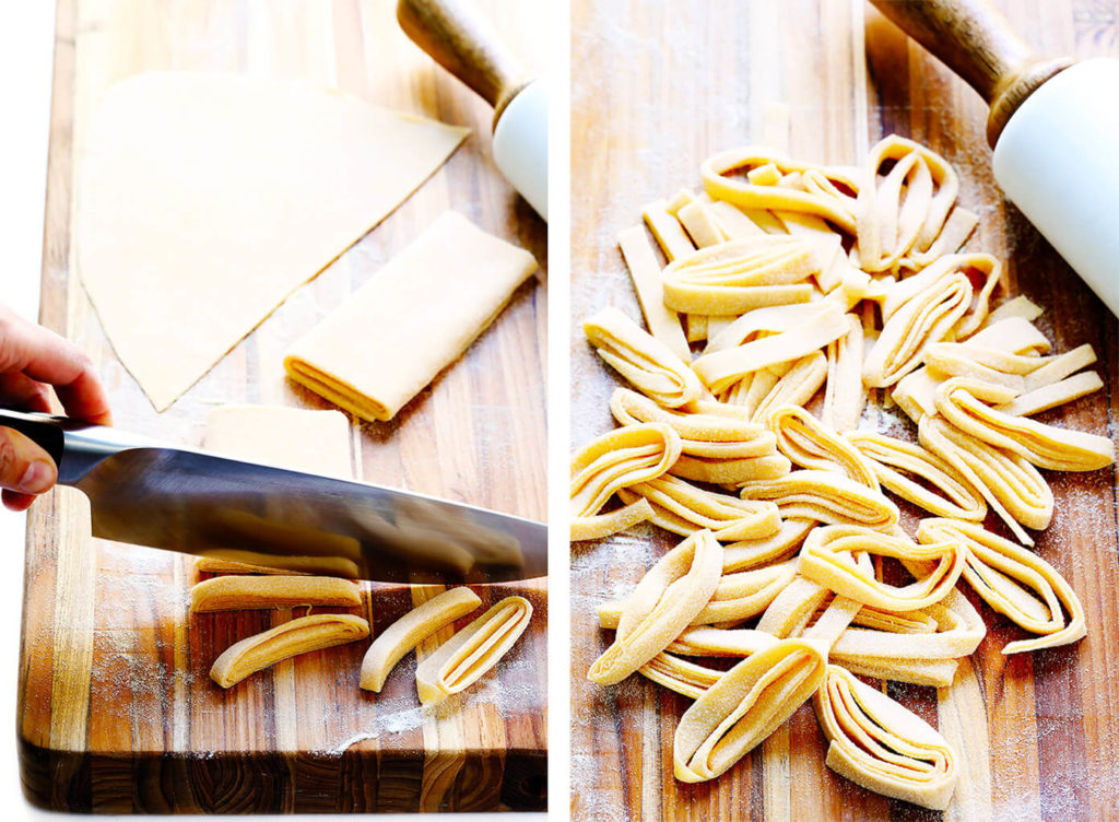 fresh pasta being chopped on wooden board