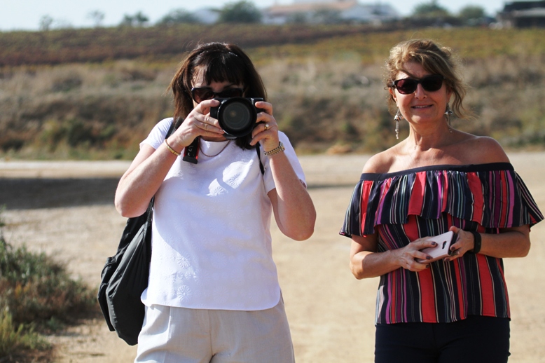 two women taking photos on the beach in Portugal