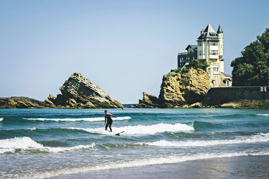surfer riding waves in Biarritz