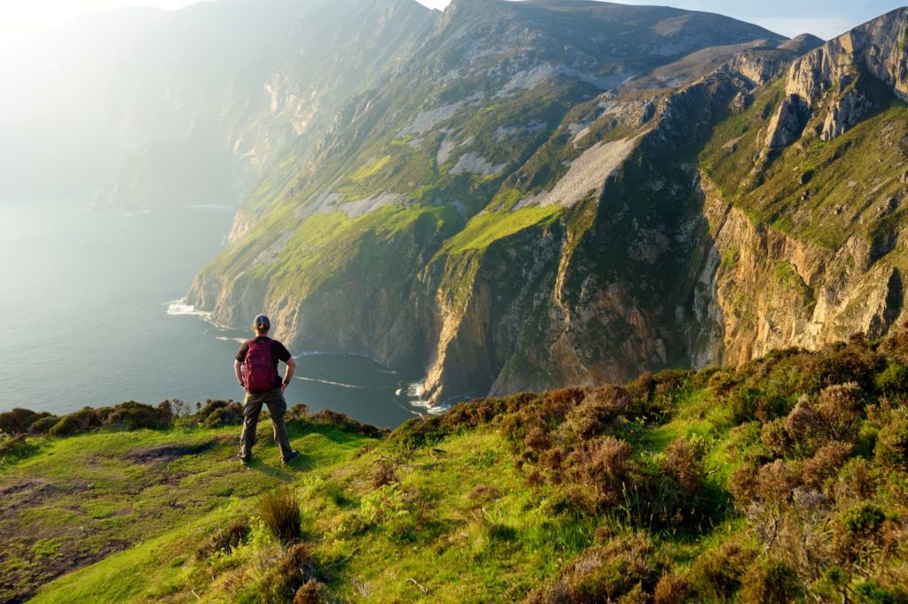 man hiking along coast near Donegal