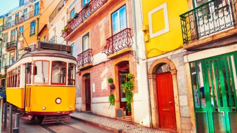 lisbon tram in colourful street