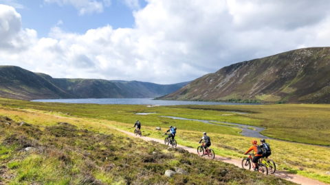 cycling group on trail in scotland