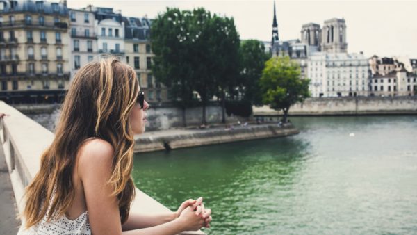 woman looks at river in paris