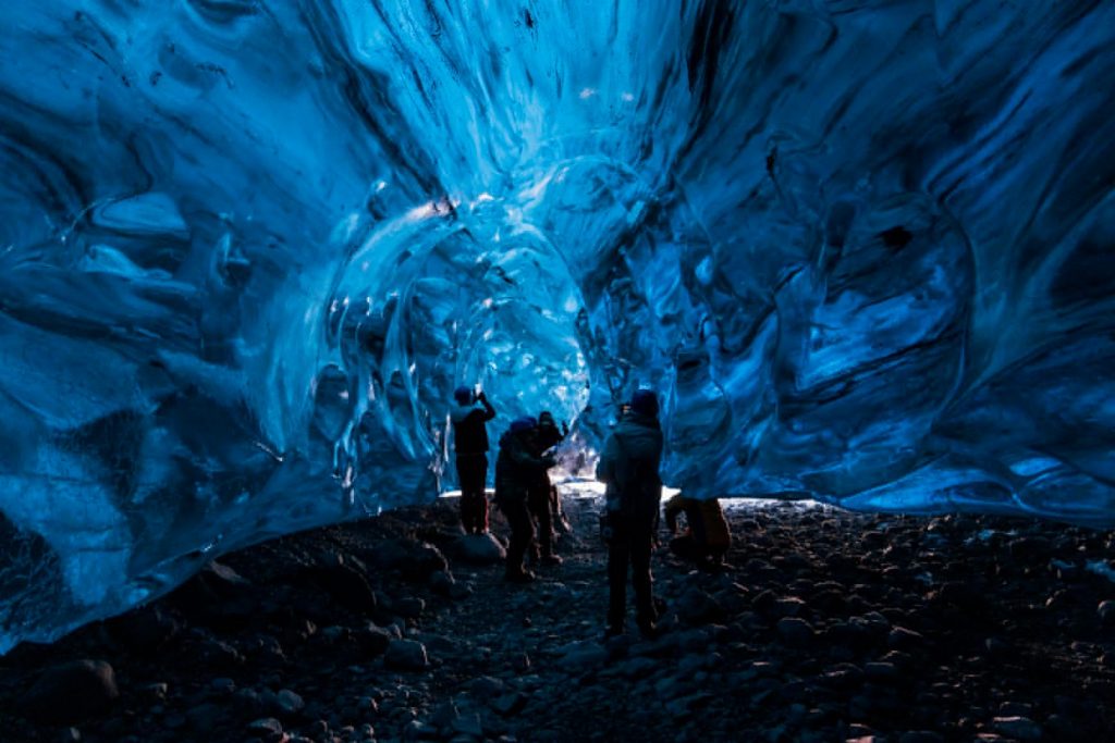 People exploring the ice cave in Iceland