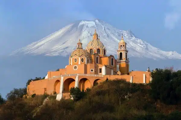 church in the foreground of a volcano