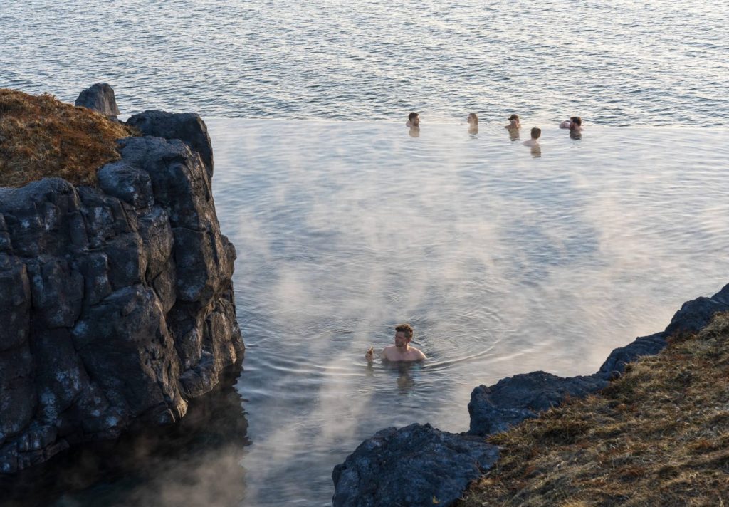 people in the secret lagoon in iceland