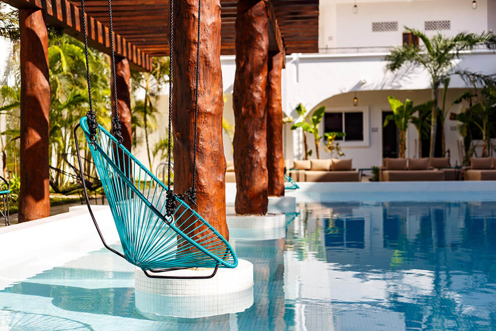 a swing seat above a swimming pool in playa del carmen
