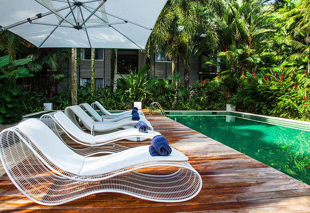 sun loungers by swimming pool in costa rica