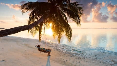 person in a hammock in the maldives