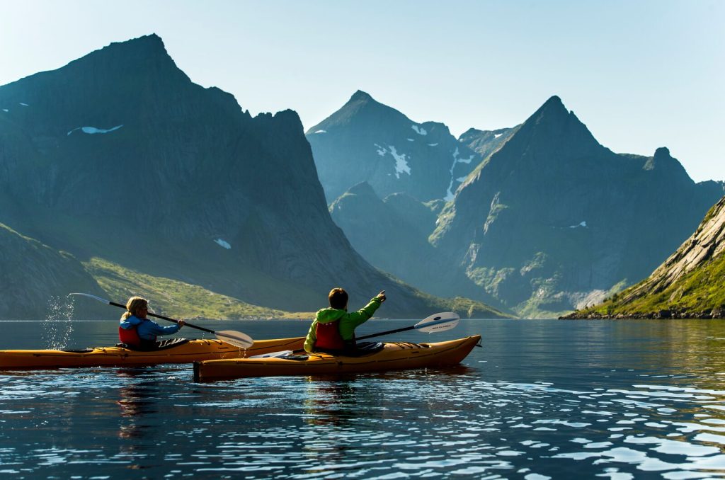 two people kayaking in reine lofoten norway