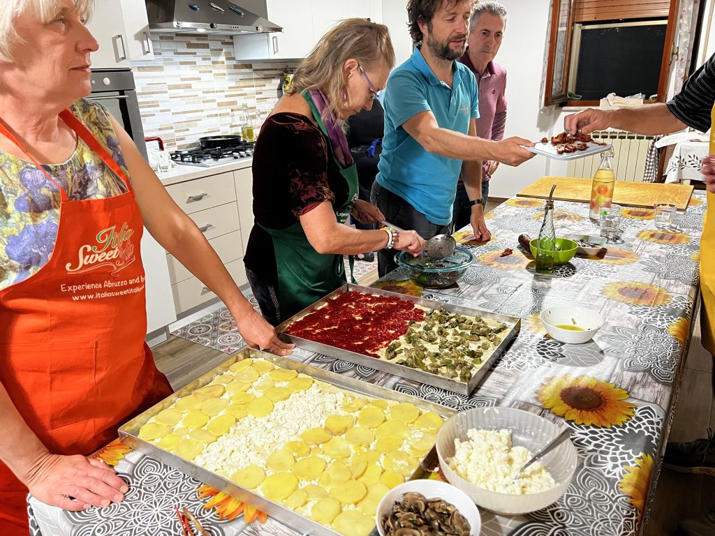group of people cooking italian food