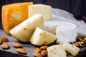 Mix of different cheeses on a plate including Camembert
