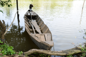Sampan boat docked in southeastern Vietnam with small motor attached