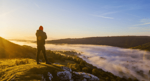 Man standing on the edge of a mountain in Wales on a UK walking retreat