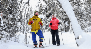 Couple snowshoeing in the Arctic Lakeland, Kainuu