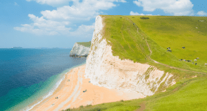 image of white cliffs in Dorset with the sandy beach at the bottom