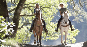 Women riding through the forest in Siena, Italy