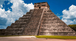 Large stone pyramid with steps rising up to a platform 