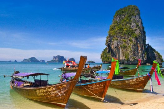 boats on a beach in southern thailand